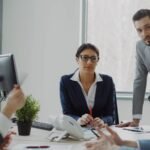 Business professionals collaborating in a modern office meeting.