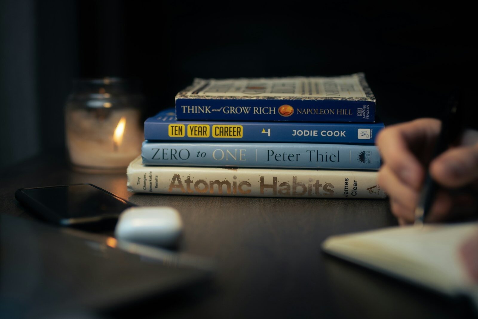 a stack of books sitting on top of a wooden table